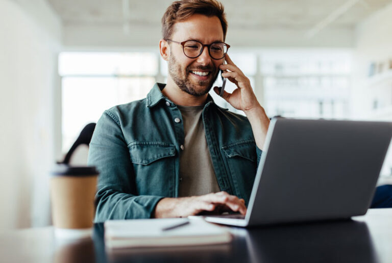 Westpark Man On Phone with Support Using Laptop